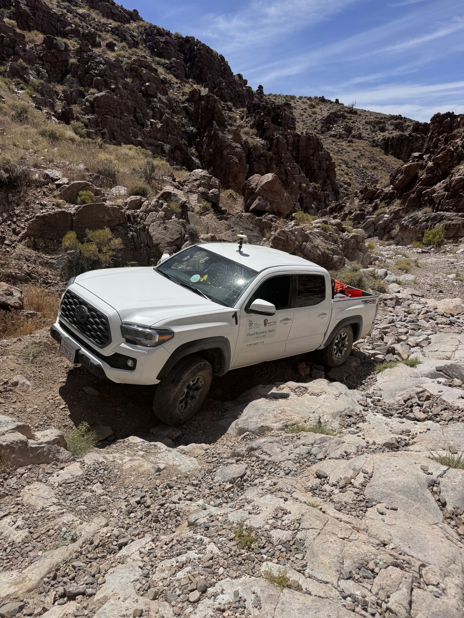 SCA Flood Recovery Team truck navigating washed-out Echo Canyon Road in Death Valley